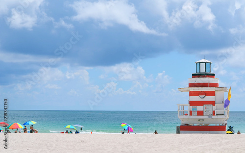 Lifeguard station, beach umbrellas and bathers at Southpointe Park Beach,Miami Beach,Florida