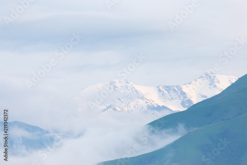 mountains from afar and clouds over the mountains © donikz