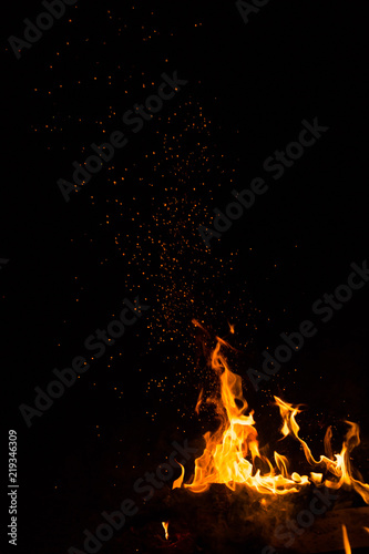 Flame of fire with sparks on a black background