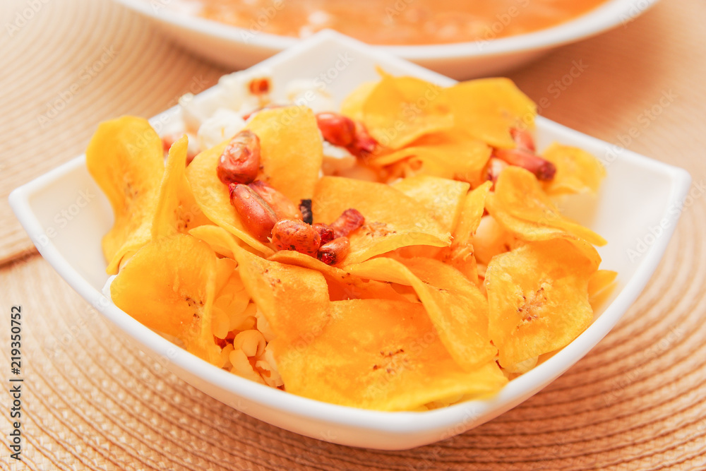 Close up of Banana chips chifles lying in small white bowl Close up of Banana chips chifles lying in small white bowl