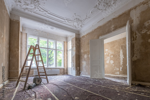 renovation concept - ladder in empty  apartment room during restoration or refurbishment photo