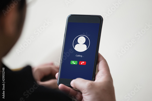 Voice call concept on the screen. Man hand holding smartphone doing voice call to someone.