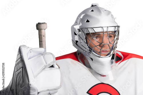 Photography Male ice hockey player in helmet holding hockey stick on a white