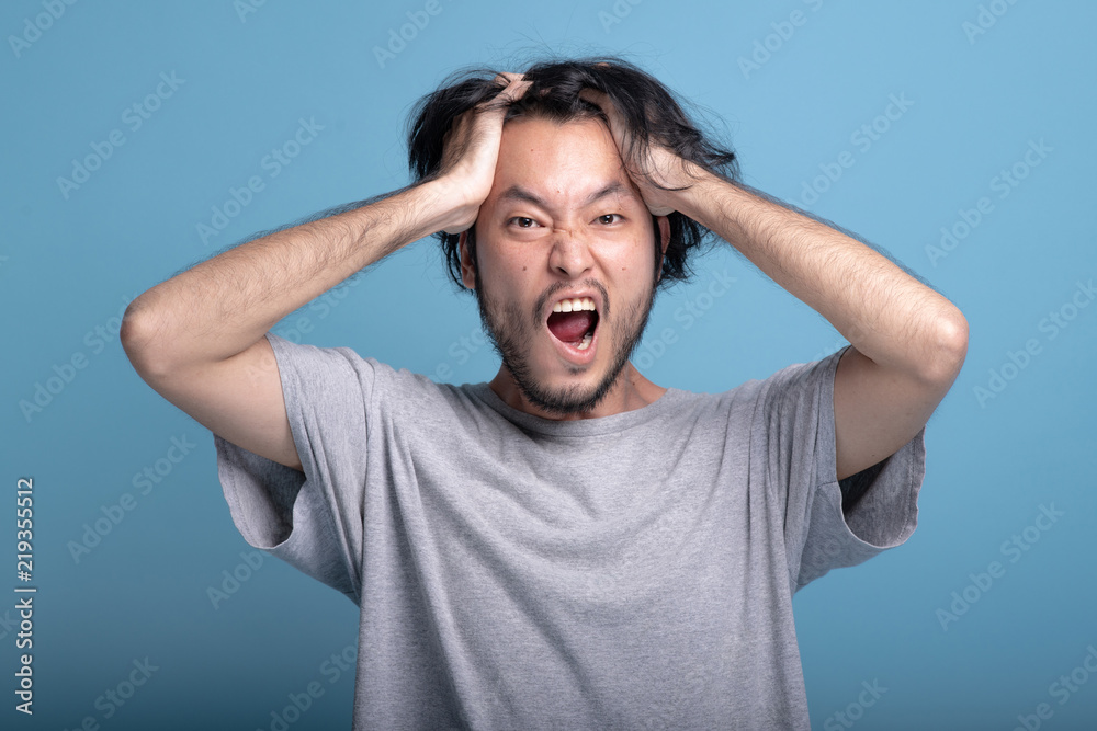 Young bearded man excited shocking pose in blue background. Young bearded man excited shocking pose in blue background.