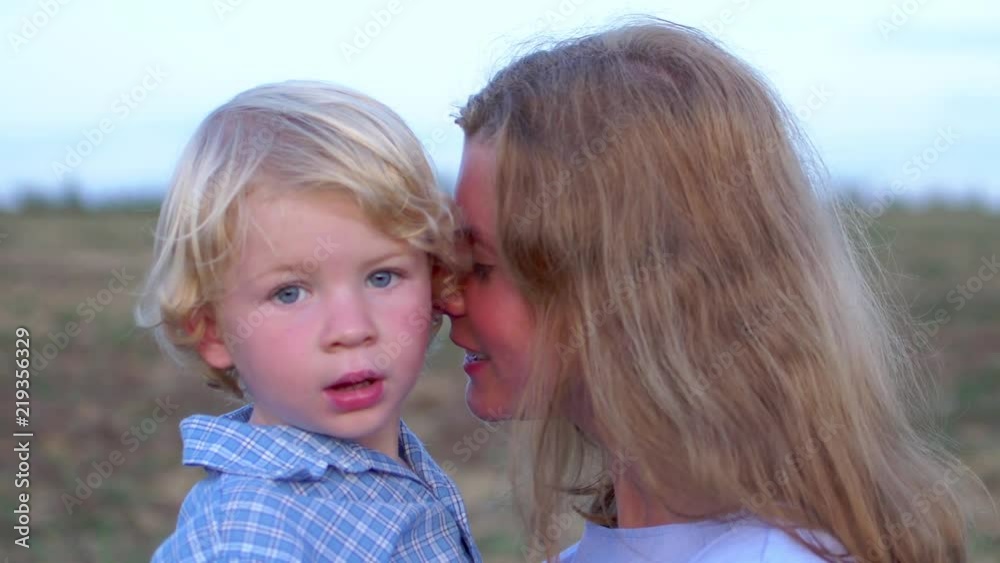 Portrait of happy young beautiful mather with smiling boy on nature outdoor Portrait of happy young beautiful mather with smiling boy on nature outdoor