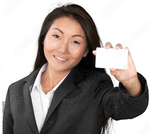 Portrait of young businesswoman holding card isolated on white