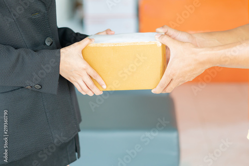  Side view of happy young woman receive a cardboard box