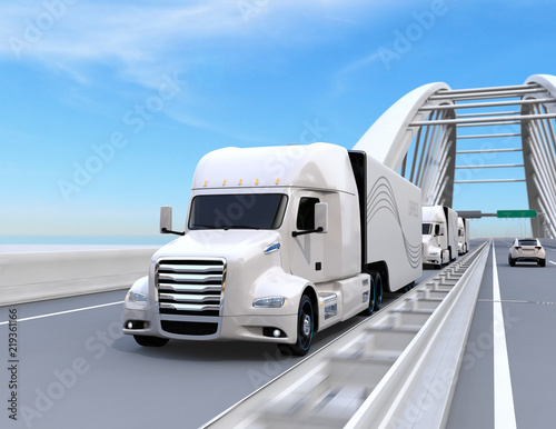 A fleet of white self-driving Fuel Cell Powered American Trucks driving on highway. 3D rendering image.