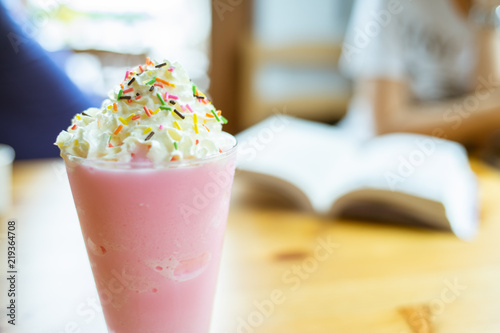 Glasses of pink milk smoothies, milkshake or cocktail on wooden background.Close up focus.