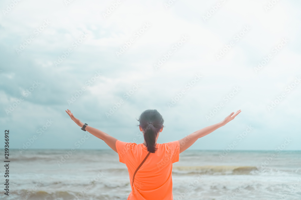 Freedom Woman playing at summer beautiful beach feel relax and fun with blue sky. Freedom Woman playing at summer beautiful beach feel relax and fun with blue sky.