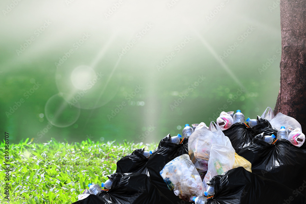 garbage waste, heap of garbage plastic waste black and trash bag many at  river park nature tree sunshine background, pollution lots waste plastic  trash, pile of plastic bags waste garbage many Stock