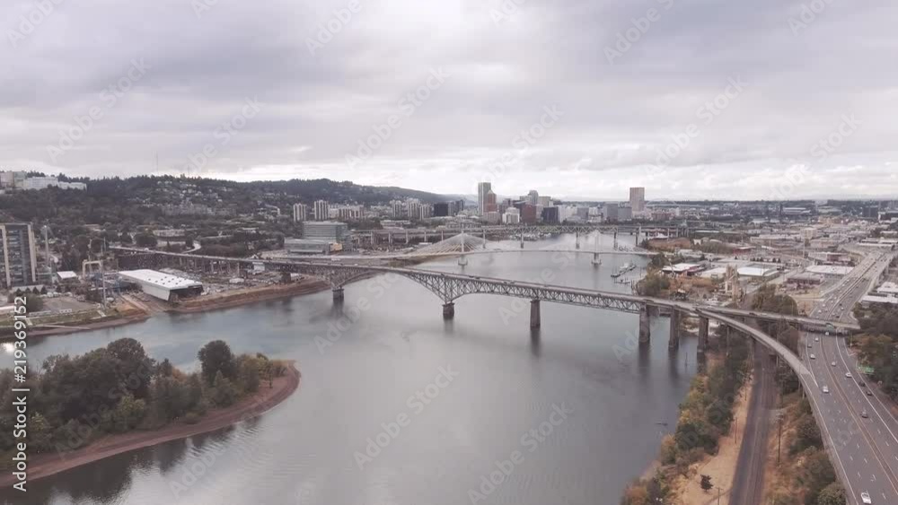 Wide aerial push-in on Portland downtown from over Willamette River