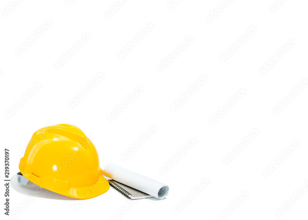 Yellow helmet with notebook and documents on isolated white background. Engineers or business concept. Yellow helmet with notebook and documents on isolated white background. Engineers or business concept.