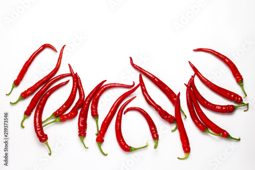 Red hot chili pepper randomly laid out on a white background. Fl