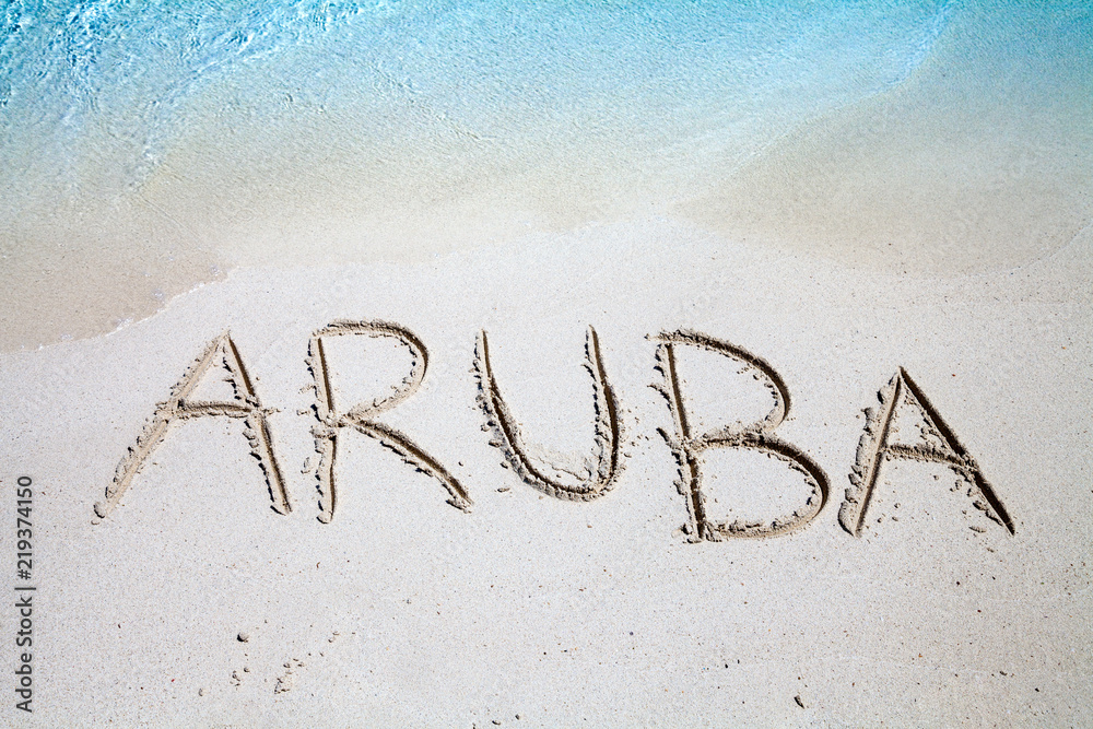 The inscription of Aruba on the beach of white sand