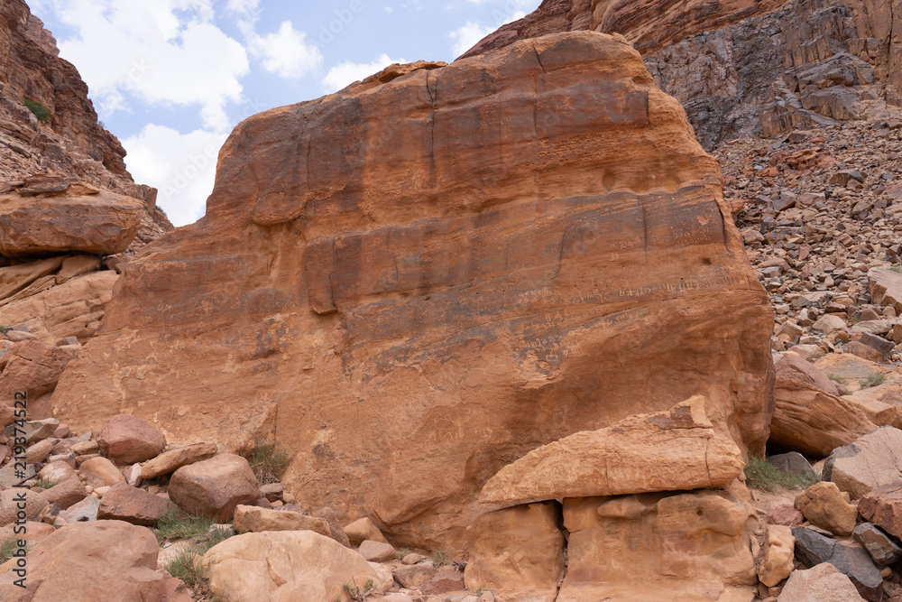 Rock with nabatean petroglyphs and inscriptions in Wadi Rum desert, Jordan