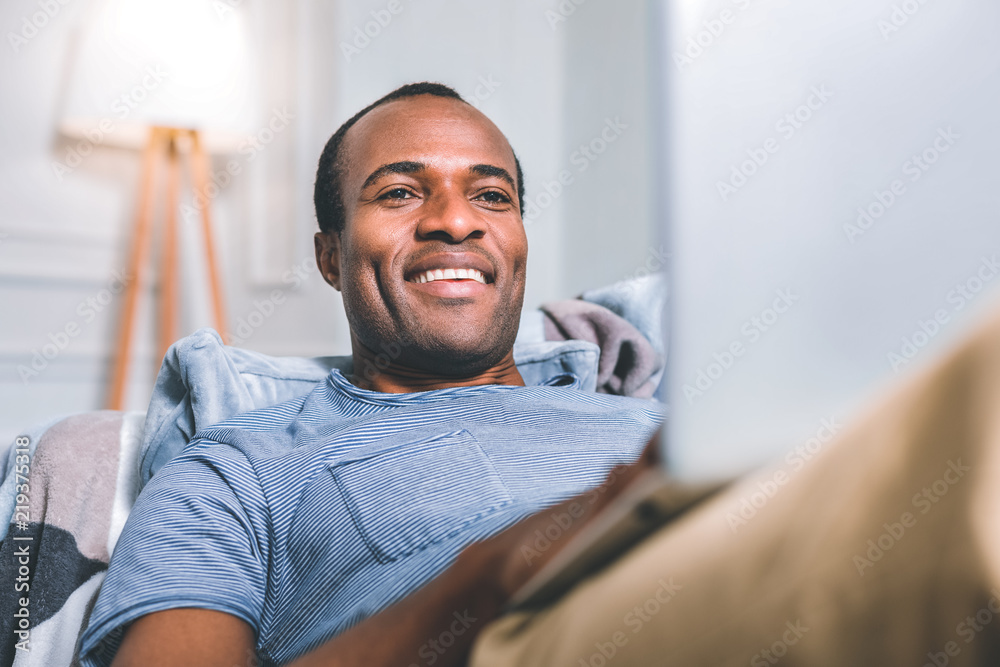 Amazing dreams. Handsome attractive man laying on the sofa while dreaming Amazing dreams. Handsome attractive man laying on the sofa while dreaming