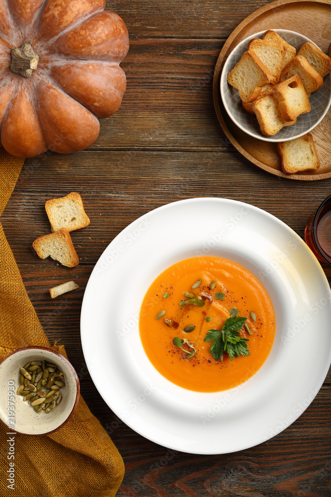 pumpkin soup in plate on wooden boards, food flat lay pumpkin soup in plate on wooden boards, food flat lay