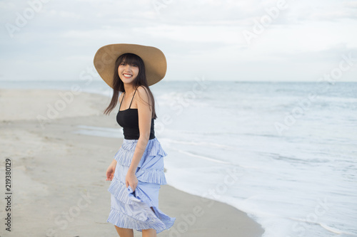 Beautiful girl smiling happily on a sunny day, Hua Hin beach, Thailand