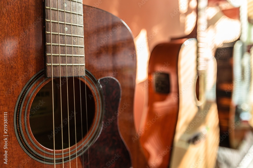Fototapeta premium Three Guitars Standing in Shop - Close Up