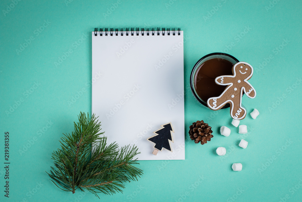 Christmas mock up blank greeting card. Fir tree branches, cup with cocoa, gingerbread and decorations over green paper background. Flat lay. Top view. Copy space Christmas mock up blank greeting card. Fir tree branches, cup with cocoa, gingerbread and decorations over green paper background. Flat lay. Top view. Copy space
