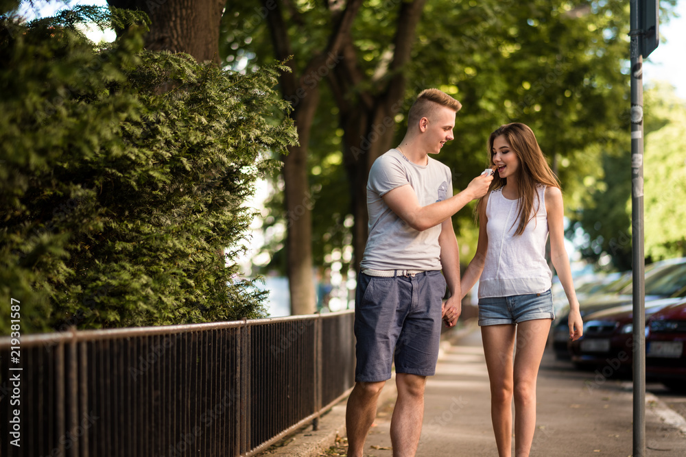 Smiling teenagers in love holding hands outside Smiling teenagers in love holding hands outside