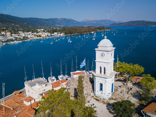 The clock tower of Poros island, Greece. Aerial drone photo