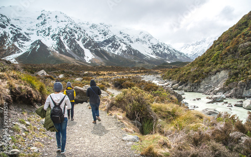 Group of asian tourist walking in Hooker Valley tracks on the way to Aoraki / Mount Cook the highest mountains in New Zealand.