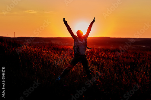 Healthy woman celebrating during a beautiful sunset. Happy and Free.