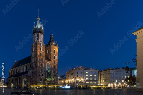 Beautiful view of the famous Saint Mary's Church Basilica and the main market square in the historic center of Krakow, Poland in the blue hour light