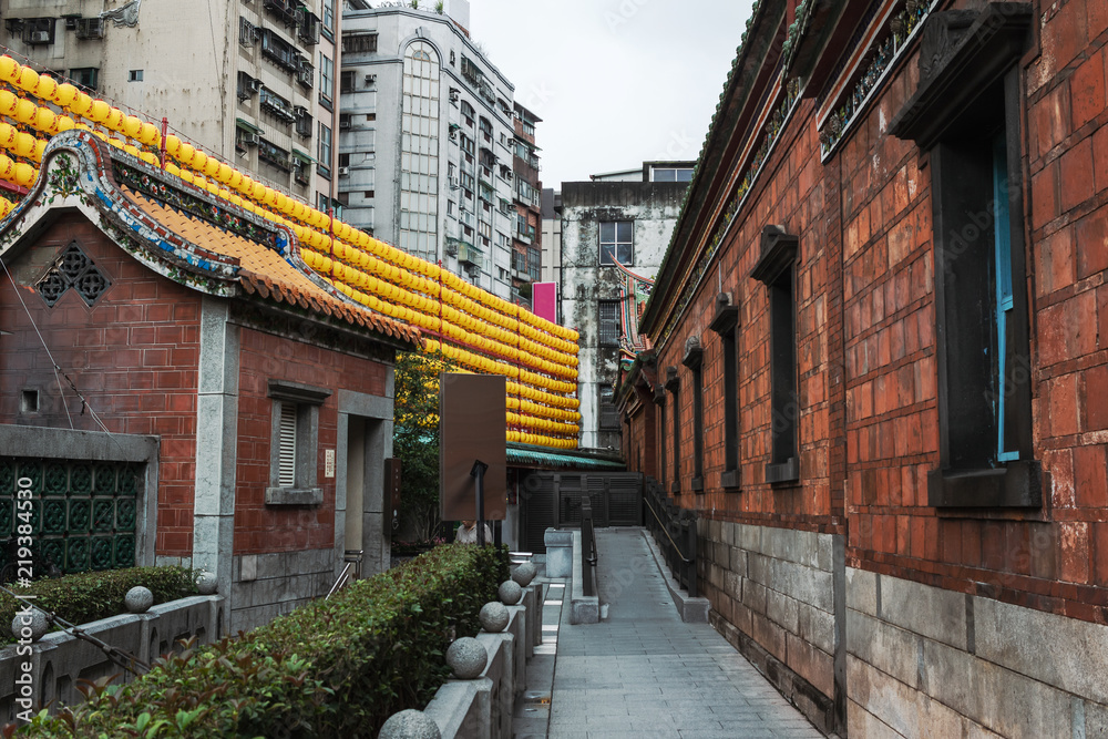 Taipei Baoan Temple and yellow lanterns and cityscape behind in Taiwan 02