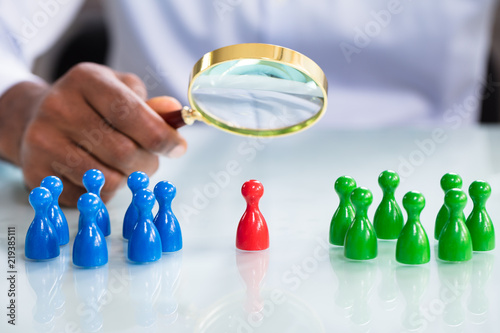 Photos Male Looking At Colorful Pawns With Magnifying Glass