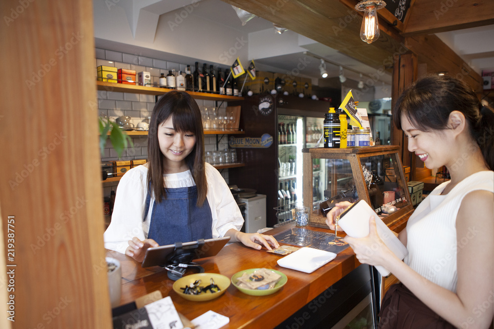 カフェのお会計をすませる女性 カフェのお会計をすませる女性