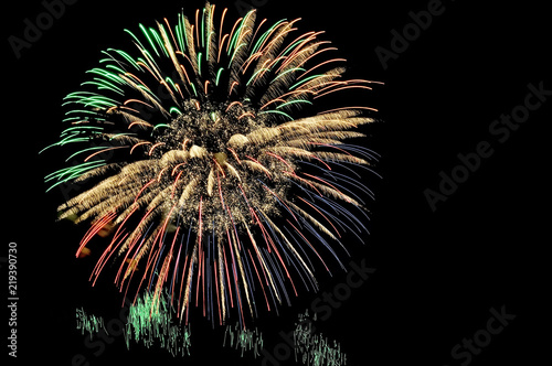 Flash of multicolored fireworks on black night sky