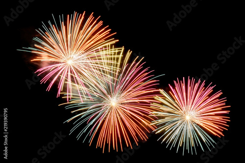 Flashes of multicolored fireworks on black background