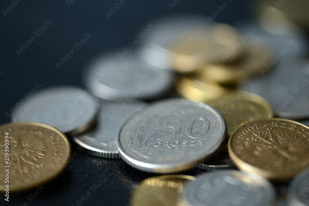 A pile of Polish coins scattered on a dark background close up A pile of Polish coins scattered on a dark background close up