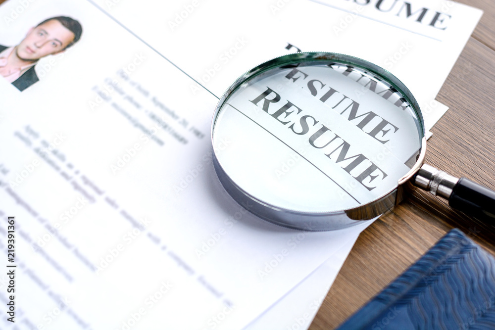 
Resume and pen on a wooden table. 