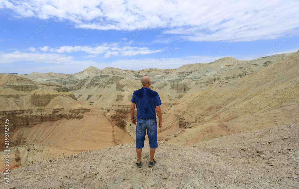 man on top of volcano in summer