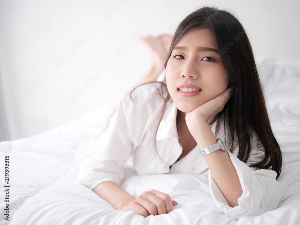 Happy Asian woman relaxing on bed, lifestyle concept. Happy Asian woman relaxing on bed, lifestyle concept.