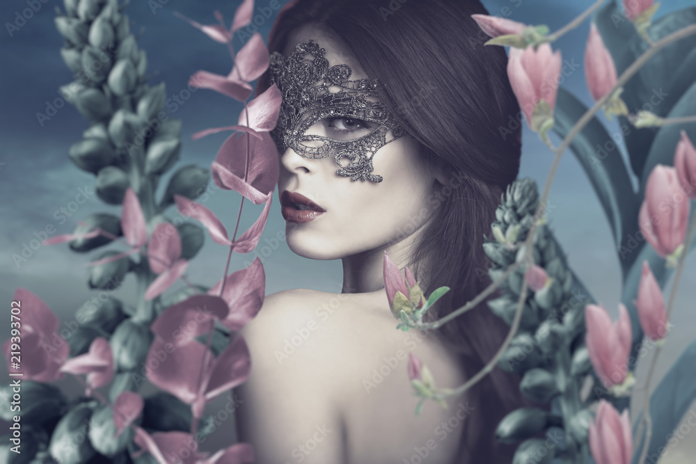 surreal portrait of young woman with lace mask in fantasy garden