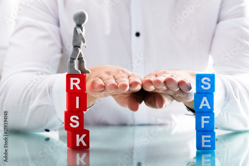 Person assisting human figure while moving from risk to safe