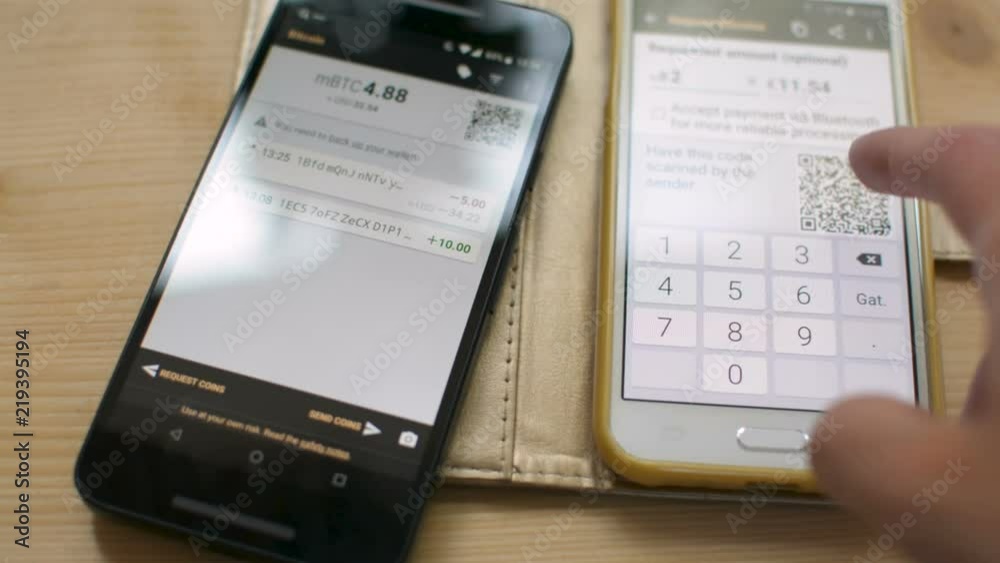 Starting Bitcoin transaction between smartphones by scanning QR code, future of retail in shops, digital cash concept