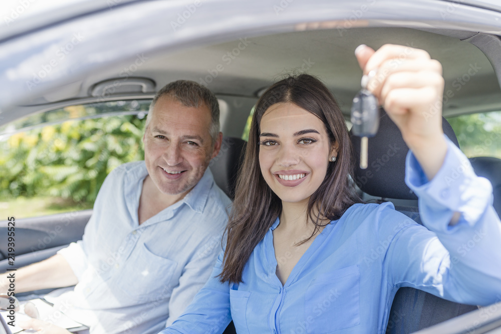 Happy driving student with a car keys Happy driving student with a car keys