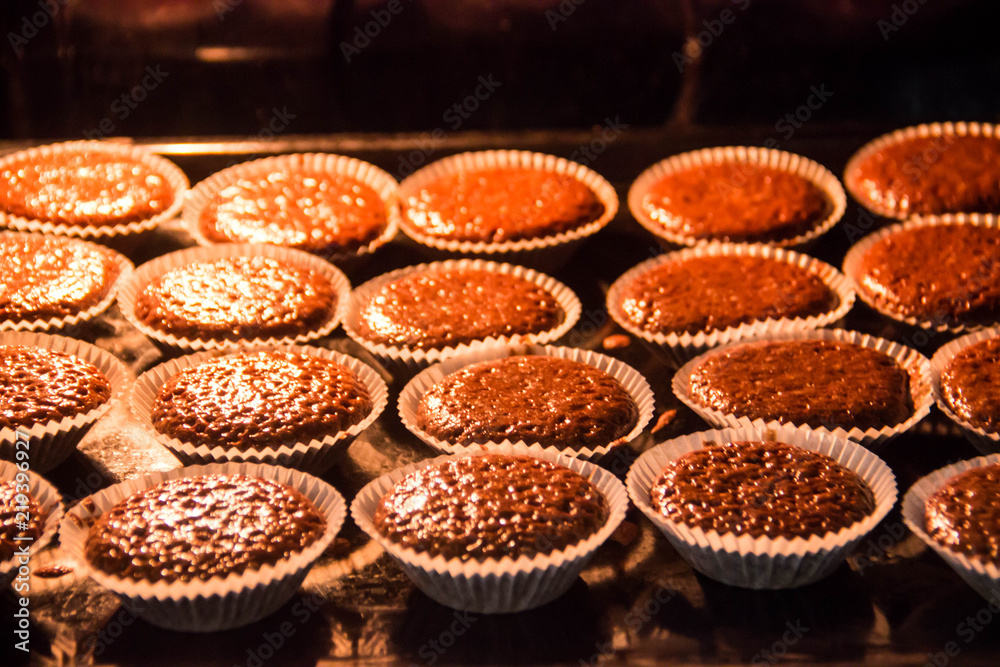 Chocolate muffins are baked in the oven