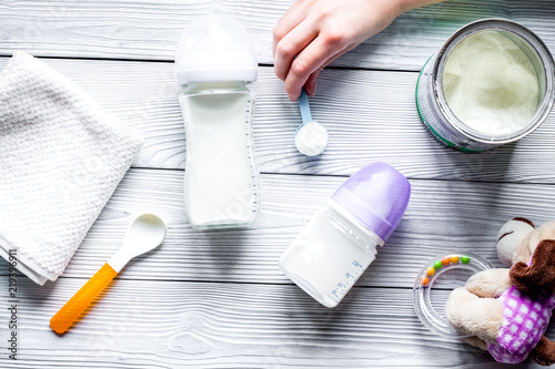 preparation of mixture baby feeding on wooden background top vie