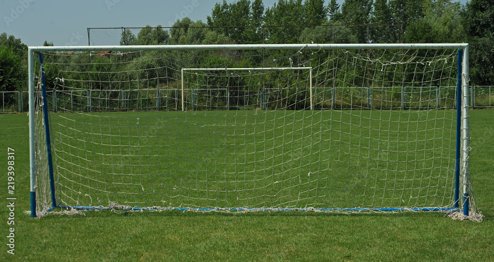 Fototapeta premium View on two goals on football field, on in front and second in background