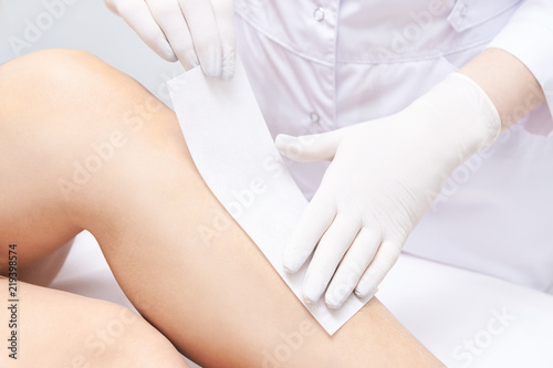 Waxing woman leg. Sugar hair removal. laser service epilation. Salon wax beautician procedure © elenavolf