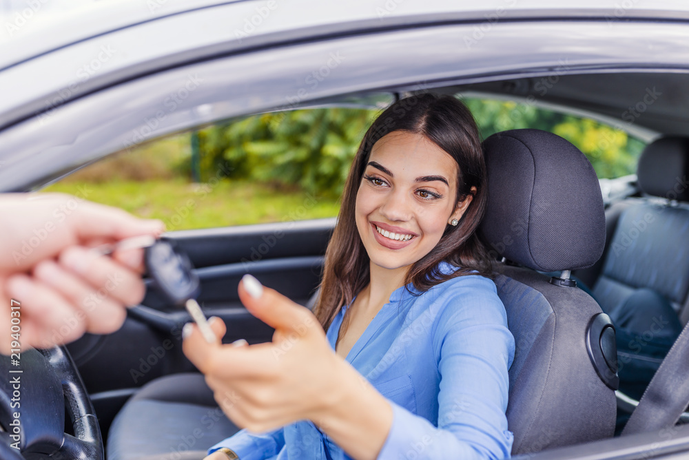 Auto business, car sale, transportation, people and ownership concept - close up of car salesman giving key to new owner or customer Auto business, car sale, transportation, people and ownership concept - close up of car salesman giving key to new owner or customer