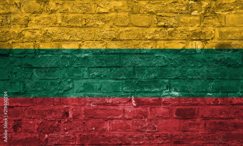Flag of Lithuania over an old brick wall background, surface