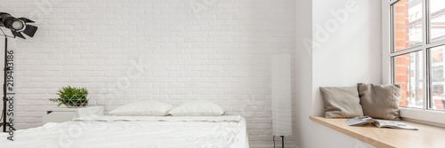 Bedroom with brick wall photo